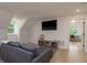 Cozy living area featuring a comfortable sofa, TV, and view into a bright office space at 2395 Campbell Rd, Clearwater, FL 33765