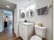 Bathroom featuring granite countertop vanity, mirror, toilet, and view of bedroom at 2400 Winding Creek Blvd # 14-201, Clearwater, FL 33761