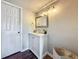 Stylish bathroom featuring a white vanity, updated faucet, mirror, contemporary lighting, and neutral wall paint at 2400 Winding Creek Blvd # 14-201, Clearwater, FL 33761