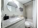 Bathroom with granite countertop vanity, toilet, and shower-tub combination with gray tile surround at 2400 Winding Creek Blvd # 14-201, Clearwater, FL 33761