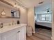 Bathroom vanity featuring stainless steel fixtures and view to the main bedroom at 2400 Winding Creek Blvd # 14-201, Clearwater, FL 33761
