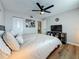 Bedroom featuring wood floors, a ceiling fan, closet and a television on top of a black shelf at 2400 Winding Creek Blvd # 14-201, Clearwater, FL 33761