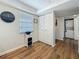 Hallway with built-in shelving unit with a laundry area adjacent to an adjacent room at 2400 Winding Creek Blvd # 14-201, Clearwater, FL 33761