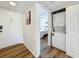 Hallway featuring a closet with a stacked washer and dryer, leading to the main bedroom at 2400 Winding Creek Blvd # 14-201, Clearwater, FL 33761