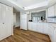 Bright kitchen featuring ample cabinet space, hardwood floors, and modern appliances at 2400 Winding Creek Blvd # 14-201, Clearwater, FL 33761