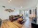 Comfortable living room featuring contemporary furniture, a rug, and balcony access at 2400 Winding Creek Blvd # 14-201, Clearwater, FL 33761