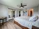 Spacious main bedroom with ceiling fan, sliding door with patio view, and wood floors at 2400 Winding Creek Blvd # 14-201, Clearwater, FL 33761
