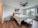 Main bedroom featuring a view to a window, ceiling fan and wood floors at 2400 Winding Creek Blvd # 14-201, Clearwater, FL 33761
