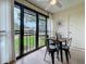 Screened-in patio features a small table and chairs with a view of the lawn outside at 2400 Winding Creek Blvd # 14-201, Clearwater, FL 33761