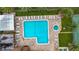 Aerial view of a community pool with ample lounge chairs, jacuzzi, and surrounding landscaping at 2400 Winding Creek Blvd # 14-201, Clearwater, FL 33761