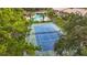 Overhead shot featuring a tennis court and pool surrounded by lush landscaping at 2400 Winding Creek Blvd # 14-201, Clearwater, FL 33761