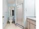 Bathroom featuring a vanity, toilet, and glass enclosed shower at 2418 Deltona Blvd, Spring Hill, FL 34606