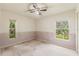 Bedroom featuring two windows and wallpaper trim at 2418 Deltona Blvd, Spring Hill, FL 34606