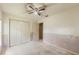 Bedroom featuring a fan, closet, and view of attached bath at 2418 Deltona Blvd, Spring Hill, FL 34606