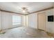 Bedroom with large closet, wallpaper trim, ceiling fan, and window view at 2418 Deltona Blvd, Spring Hill, FL 34606