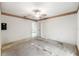 Spacious bedroom with ceiling fan, wallpaper trim, and view into kitchen at 2418 Deltona Blvd, Spring Hill, FL 34606
