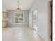 Bright dining area with neutral tile flooring, chandelier and sliding door at 2418 Deltona Blvd, Spring Hill, FL 34606
