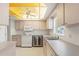 Bright, efficient kitchen with a modern wine cooler, white appliances, and ample cabinet space for storage at 2418 Deltona Blvd, Spring Hill, FL 34606