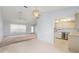 Open-concept living area seamlessly connects the kitchen to the living room with abundant natural light at 2418 Deltona Blvd, Spring Hill, FL 34606