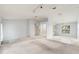 Bright, open living room features vaulted ceilings, large windows, and seamless access to the kitchen at 2418 Deltona Blvd, Spring Hill, FL 34606