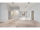 Spacious living room with natural light, shelving, and seamless transition to kitchen and outdoor spaces at 2418 Deltona Blvd, Spring Hill, FL 34606