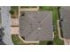Aerial view showcases the home's roof, landscaping, and brick driveway within a quiet neighborhood at 2616 Tottenham Dr, New Port Richey, FL 34655