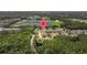 A beautiful aerial view of a community with single-Gathering homes surrounded by trees and serene lakes at 2616 Tottenham Dr, New Port Richey, FL 34655