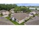 An aerial showcases the community and the rear of the home with screened in porch at 2616 Tottenham Dr, New Port Richey, FL 34655