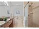 Bright bathroom featuring double sinks, granite counters, soaking tub, and glass shower at 2616 Tottenham Dr, New Port Richey, FL 34655