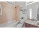 Bathroom featuring a bathtub with shower, neutral tile, and granite counters at 2616 Tottenham Dr, New Port Richey, FL 34655