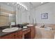 Bright bathroom featuring double sinks, granite counters, soaking tub, and glass shower at 2616 Tottenham Dr, New Port Richey, FL 34655