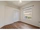 Bedroom featuring wood-look floors, a window, and a closet at 2616 Tottenham Dr, New Port Richey, FL 34655