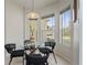 Sunny breakfast nook features a glass table, stylish chairs, and bright, airy windows at 2616 Tottenham Dr, New Port Richey, FL 34655
