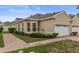 Charming single-story home with a brick walkway, manicured landscaping, and an attached two-car garage at 2616 Tottenham Dr, New Port Richey, FL 34655