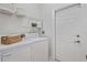 Well-lit laundry room features a full-sized washer and dryer at 2616 Tottenham Dr, New Port Richey, FL 34655