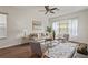 Bright living room featuring stylish furniture, hardwood floors, a ceiling fan, and large windows at 2616 Tottenham Dr, New Port Richey, FL 34655