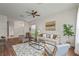 Inviting living room with stylish furniture, hardwood floors, a ceiling fan, and an open floor plan at 2616 Tottenham Dr, New Port Richey, FL 34655