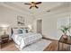 Bright main bedroom featuring hardwood floors, a ceiling fan, stylish decor, and ample natural light at 2616 Tottenham Dr, New Port Richey, FL 34655