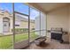 The screened patio features a grill, with access to the home's backyard at 2616 Tottenham Dr, New Port Richey, FL 34655