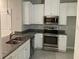 Modern kitchen featuring stainless steel appliances, granite countertops and white cabinets at 2822 Jacob Crossing Ln, Holiday, FL 34691