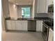 Bright kitchen with granite countertops, stainless steel appliances, and a view to the living area at 2822 Jacob Crossing Ln, Holiday, FL 34691
