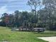 Community playground with play structures, slides, and open green space for recreational activities at 2822 Jacob Crossing Ln, Holiday, FL 34691