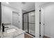 Modern bathroom featuring double sinks with granite countertops and a glass-enclosed shower at 29595 Fedora Cir, Brooksville, FL 34602