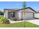 Charming one-story home featuring a two-car garage, landscaped front yard, and neutral exterior color at 29595 Fedora Cir, Brooksville, FL 34602