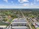 Expansive aerial view of a community with housing, waterways, and ample foliage under a partly cloudy sky at 2960 59Th S St # 303, Gulfport, FL 33707