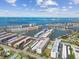 Stunning aerial view of waterfront condominiums, revealing canals, docks, and picturesque islands against a partly cloudy sky at 2960 59Th S St # 303, Gulfport, FL 33707