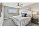 Comfortable bedroom featuring a ceiling fan, plush carpet, neutral paint, and a window with blinds for a serene retreat at 2960 59Th S St # 303, Gulfport, FL 33707