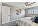 Neutral bedroom showcasing a ceiling fan, carpeting, and a window with blinds, creating a cozy and inviting space at 2960 59Th S St # 303, Gulfport, FL 33707