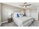 Cozy bedroom featuring a plush bed, carpet, a ceiling fan, neutral paint, and ample natural light for a comfortable setting at 2960 59Th S St # 303, Gulfport, FL 33707