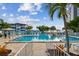 Community swimming pool surrounded by lounge chairs and tropical landscaping with buildings visible at 2960 59Th S St # 303, Gulfport, FL 33707